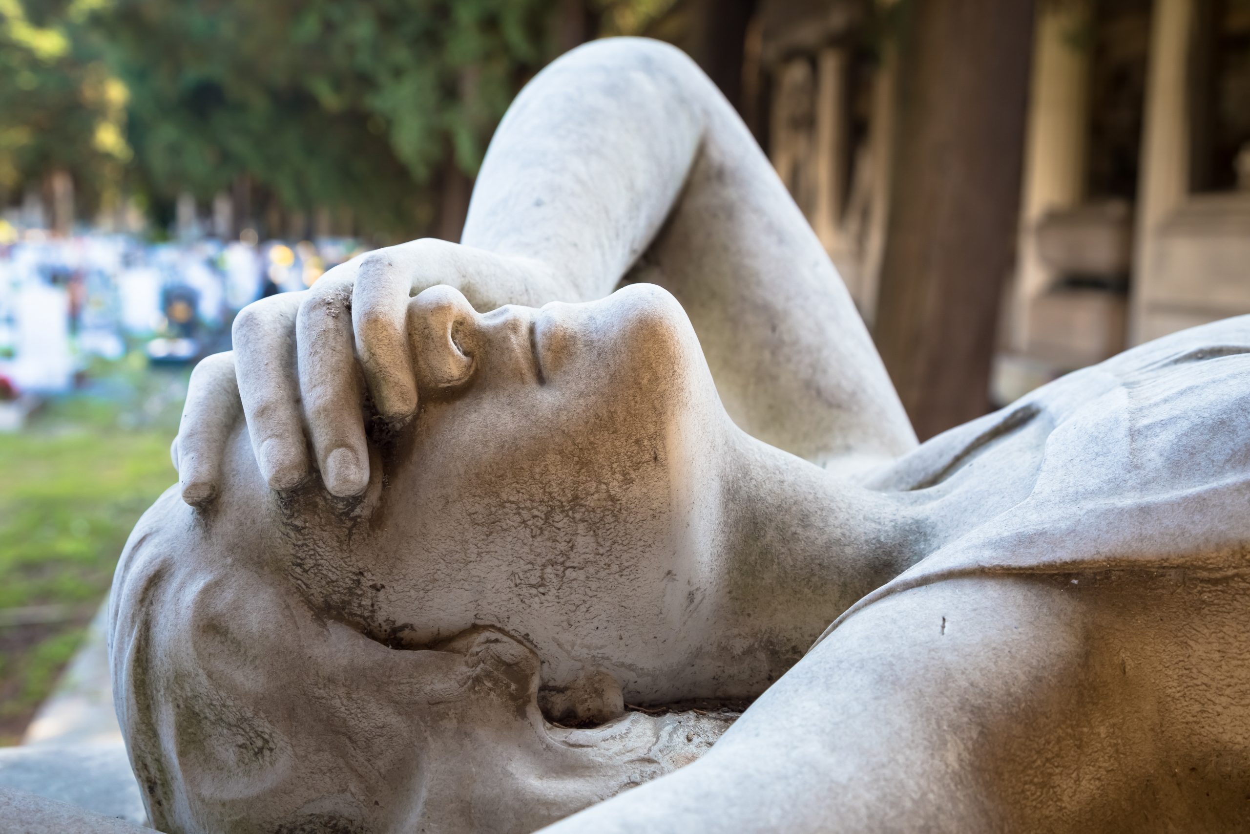 Statue of angel on a 1910 tomb located in an old Italian cemeter Statue of angel on a 1910 tomb located in an old Italian cemeter